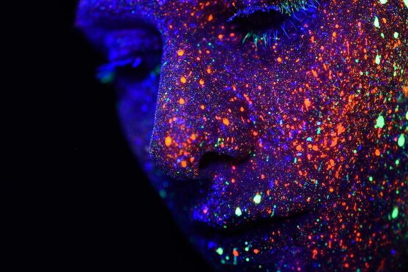 a sprinkled face of a woman with light dots