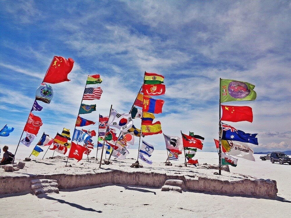 flags-in-the-salar-de-uyuni-tour-of-bolivias-salar-de-uyuni image used as feature image for bolivia and chile visa controversy for indians