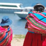women+daughter+walking+towards+ferries+shore+el+lago+titicaca+copacabana+bolivia