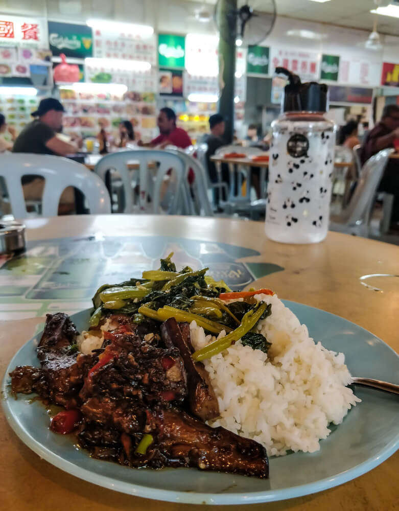 rice, fish, and vegetables in a Penang food court
